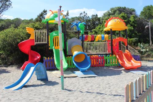 a playground with a colorful play equipment in the sand at Villa Elma in Villaputzu