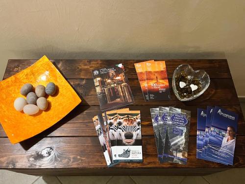 a wooden table with books and magazines on it at La Mansarda del Viandante in Castelbelforte