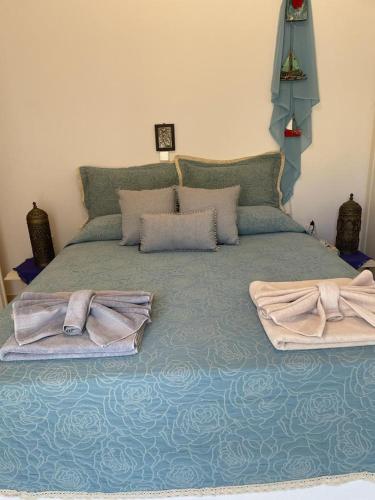 a bed with two towels sitting on top of it at Villa Amalaya in Flampouria