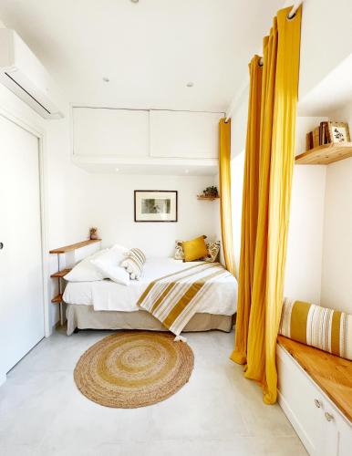 a bedroom with a bed with yellow curtains at Casa Maddy Anacapri in Anacapri