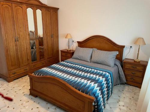 a bedroom with a bed and a dresser and a cabinet at Casa turismo rural Becar in Corullón