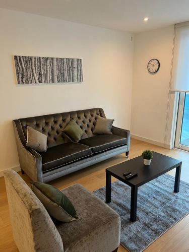 a living room with a couch and a table at Stunning 1 bedroom Apartment in Croydon in Croydon
