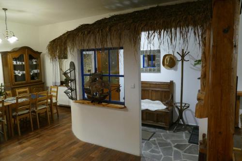 a living room with a table and a dining room at Chalupa Pohoda in Velké Karlovice