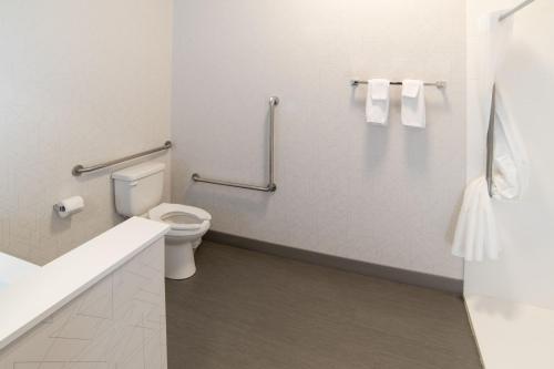 a bathroom with a toilet and a sink and towels at Holiday Inn Express & Suites - Moose Jaw by IHG in Moose Jaw