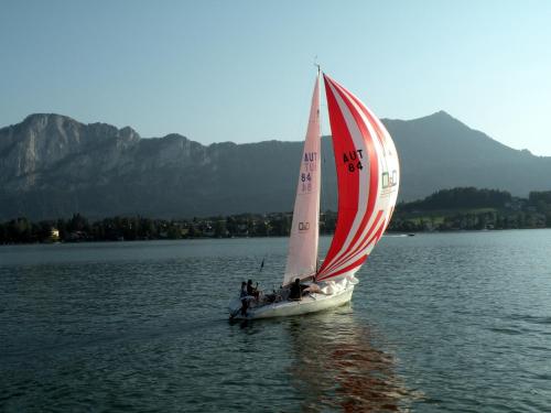 a group of people on a sail boat on the water at Hotel Krone in Mondsee