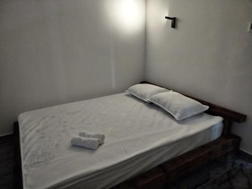 a bed with two folded towels sitting on it at FAKTOTUM in Donja Ralja