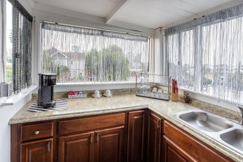 a kitchen with a sink and two windows at Big Studio with Ocean View max 6 sleepers in San Diego