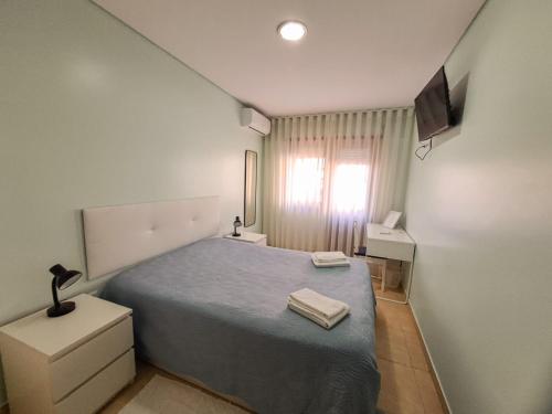 a small bedroom with a bed and a television at Private Room at Fatima's in Porto