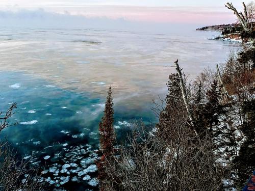 a view of a body of water with clouds at Cliff Dweller on Lake Superior in Tofte