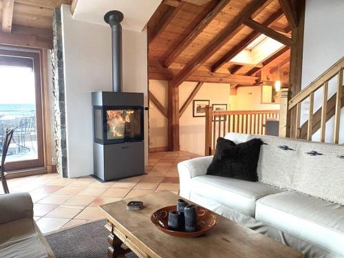 ein Wohnzimmer mit einem Sofa und einem Kamin in der Unterkunft Ferme Vauvray in Megève