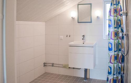 a bathroom with a sink and a shower curtain at Beautiful Home In Ronneby With Sauna in Ronneby