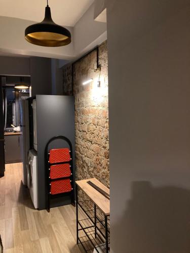 a room with a refrigerator and a wooden table at Archeo in Istanbul