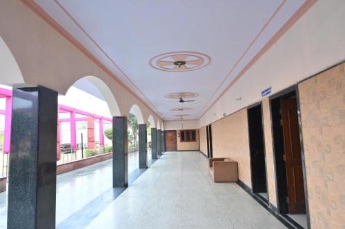 an empty hallway of a building with a ceiling at Hotel Mukund Dham-Near Mathura Railway Station in Mathura