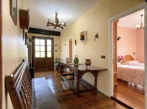 a living room with a table and a bed at Casa Rural Iratxeko-Berea in Bera