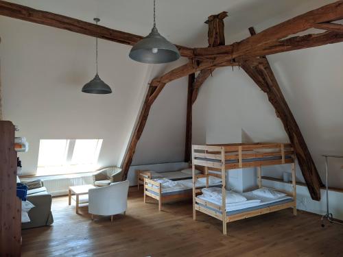 Zimmer mit 2 Etagenbetten und einem Tisch in der Unterkunft Le Nid du Hibou in Saint-Julien-de-Civry