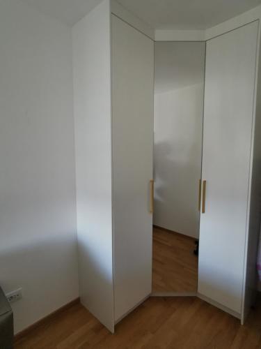 an empty room with white walls and a door at Alex LUX in Banja Luka