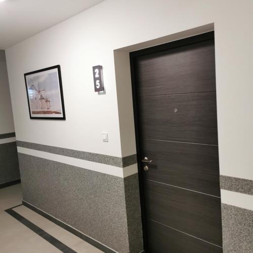 a door in a room with stripes on the wall at Alex LUX in Banja Luka