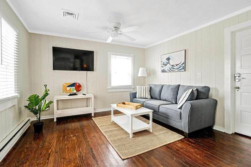 a living room with a couch and a table at Beachwalk #2 8 minute walk to the Beach in Virginia Beach