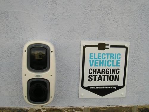 a sign on a wall with a electric vehicle charging station at Dalesgate Hotel - Self Check In in Keighley