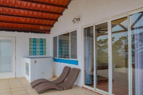 a room with sliding glass doors and a table at Villa La Vista of Panama City and magestical mountains from infinity pool in Cerro Azul