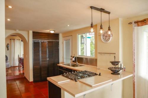 a kitchen with a sink and a stove top oven at Villa La Vista of Panama City and magestical mountains from infinity pool in Cerro Azul