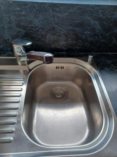 a stainless steel sink with a faucet on a counter at Castle View Big Appartment Vaduz Center in Vaduz