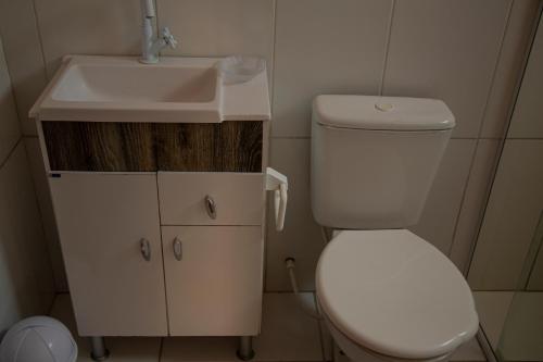 Baño pequeño con aseo y lavamanos en Chale Namaste 2, en Palhoça
