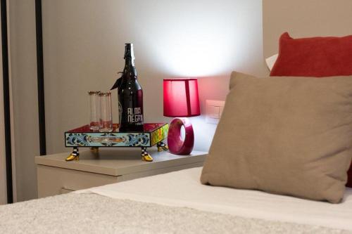 a bed with a pillow and a table with a lamp at M&G holiday house in Matera