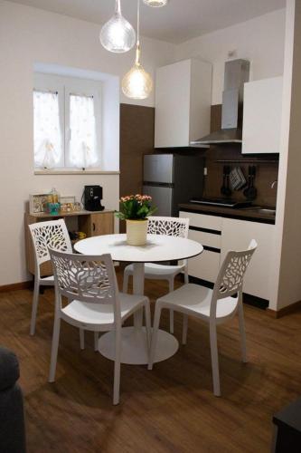 a kitchen with a white table and chairs in a room at M&G holiday house in Matera