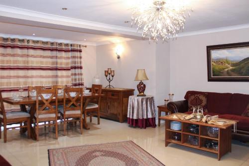 a living room with a table and a dining room at Stylish 4-Bedroom House near NEC/BHX in Solihull