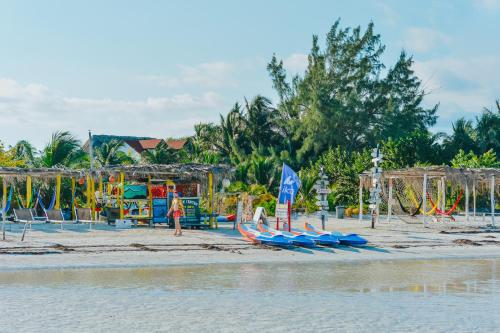 a beach with a bunch of slides and a playground at Hotel Encanto Holbox Beach Front in Holbox Island