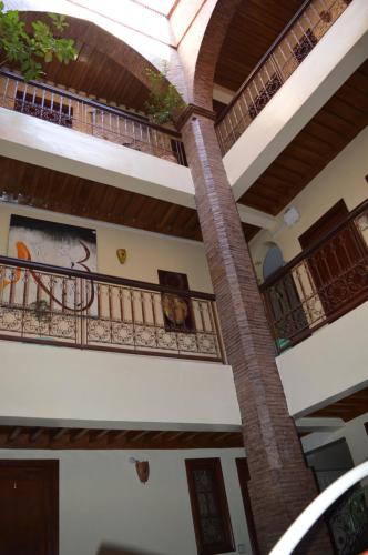 a staircase in a house with balconies at Hotel salem leksor in Marrakesh