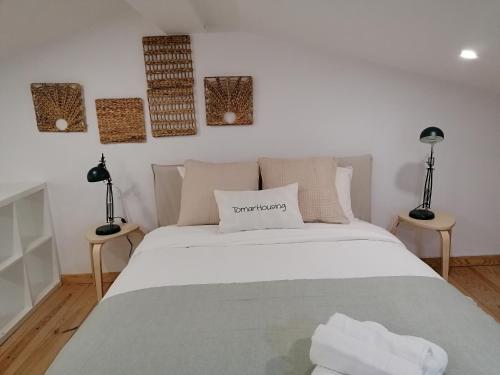 a bedroom with a white bed and two lamps at Tomarhousing - Old Town in Tomar