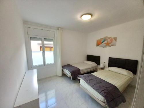 A bed or beds in a room at Rosesapparts Mairó