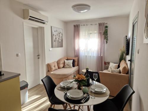 a small living room with a table and chairs at Apartments Duje in Split