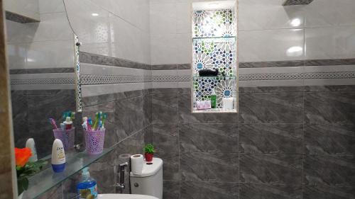 a bathroom with a sink and a toilet and a mirror at Casa Morisca in Sidi Ifni