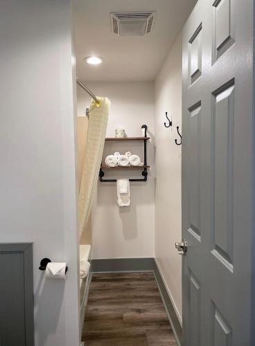 a bathroom with a toilet and a door at Canyon Motel in Wellsboro