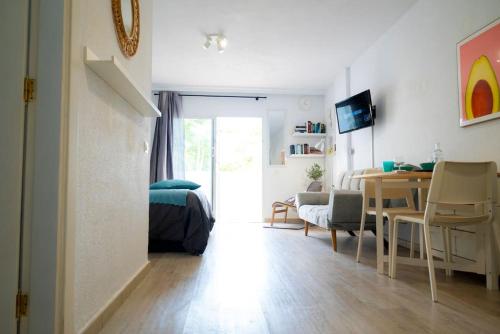 a room with a bed and a table and a desk at Las Americas studio in Playa de las Americas