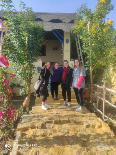 a group of women standing on the steps of a house at Kayan House in Tunis