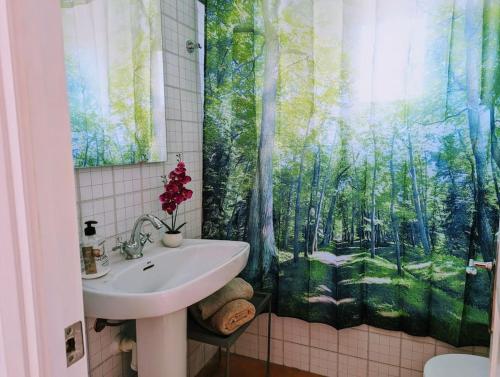 a bathroom with a sink and a shower curtain at Bella Brisa, Port d'Addaia in Port d'Addaia