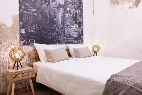 two beds in a room with a picture on the wall at PASSAGE - historic boutique suite in Haarlem