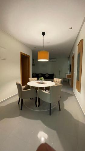 a dining table and chairs in a living room at appart hotel puerto marino in Al Hoceïma