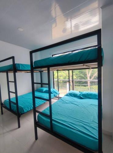 two bunk beds in a room with a window at Lujosa Mansión Privada estilo mediterráneo in Melgar