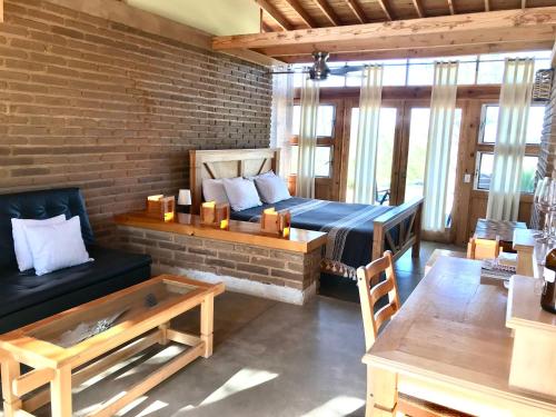 a living room with a bed and a couch at Casa Mayoral B&B Pet friendly in Valle de Guadalupe