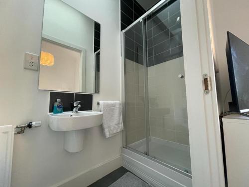 a bathroom with a sink and a shower at 2 Bedroom House with Garden Next to River Tees in Stockton-on-Tees