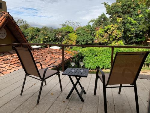 two chairs and a small table on a deck at ARANJUEZ LOFTS Santa Ana in Santa Ana