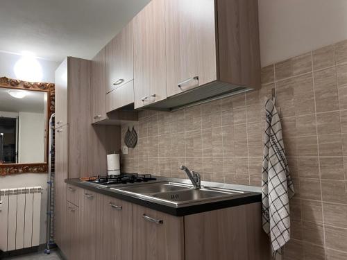 a small kitchen with a sink and a stove at Sunset House in Chioggia