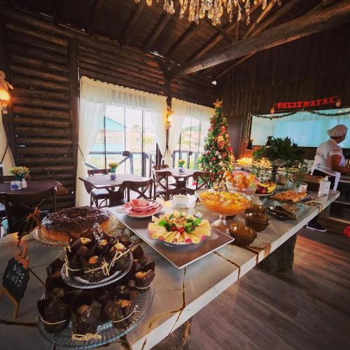 a long table with food on it in a room at Pousada Recanto do Aconchego in Florianópolis