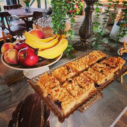 a table topped with a plate of apples and bananas at Pousada Recanto do Aconchego in Florianópolis