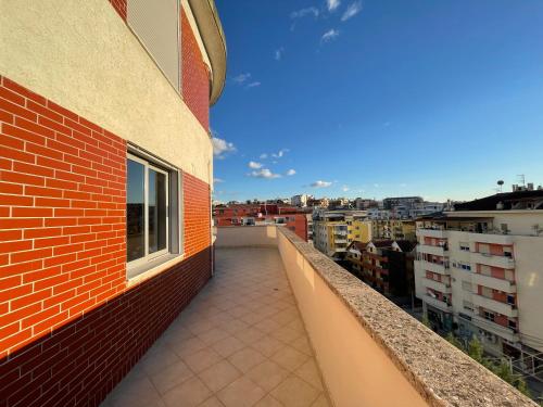 a balcony of a building with a view of a city at B&B - Private Rooms in Tirana